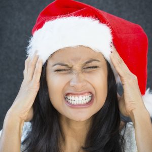 stressed woman wearing christmas hat
