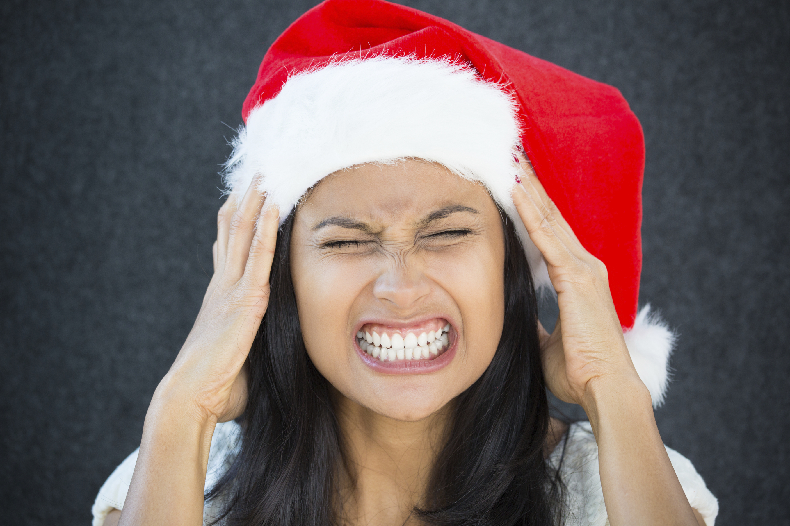 stressed woman wearing christmas hat