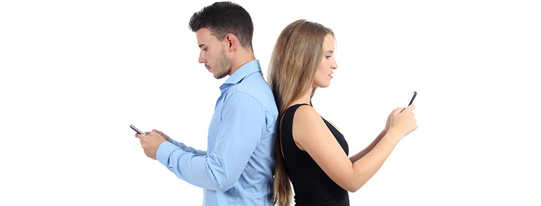 man and women being hypnotised by their phones.