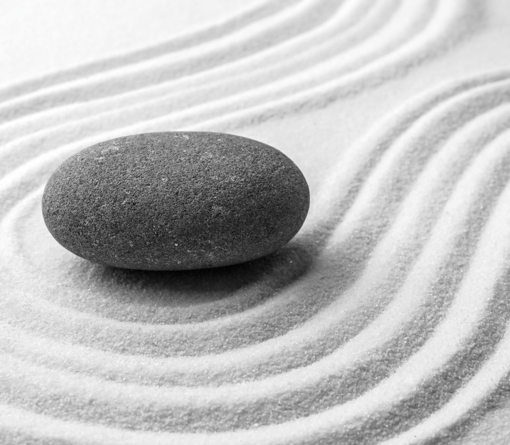 Grey stone on sand with pattern