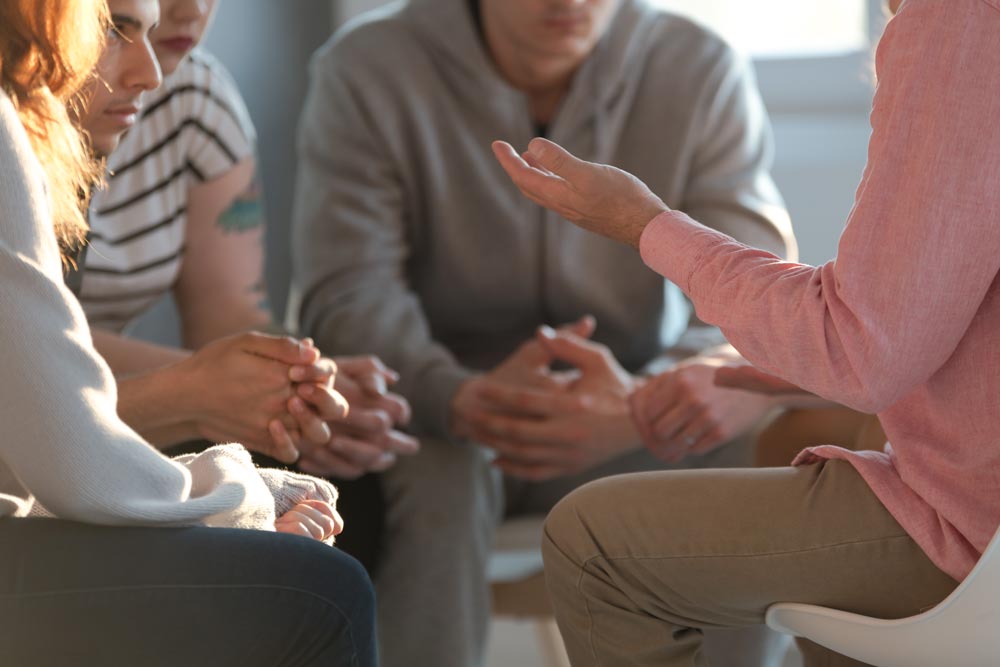 therapist talking to a group of patients about social anxiety