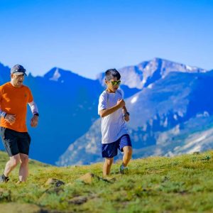 father and child running through country side