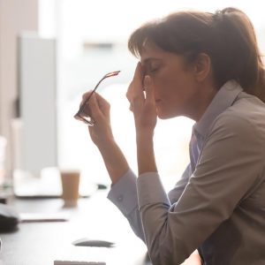 tired woman employee sitting at her desk