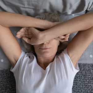 middle aged woman laying awake in bedsuffering from insomnia