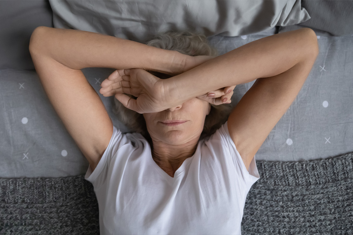 middle aged woman laying awake in bedsuffering from insomnia